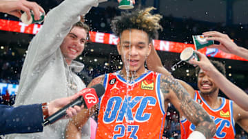 Josh Giddey #3 of the Oklahoma City Thunder and Aaron Wiggins #21 of the Oklahoma City Thunder join teammates as they dump water on Tre Mann #23 of the Oklahoma City Thunder (Photo by Ian Maule/Getty Images)