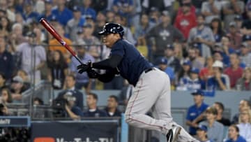 LOS ANGELES, CA - OCTOBER 27: Rafael Devers #11 of the Boston Red Sox hits an rbi single to center field for the 5-4 lead in the ninth inning of Game Four of the 2018 World Series against the Los Angeles Dodgers at Dodger Stadium on October 27, 2018 in Los Angeles, California. (Photo by Harry How/Getty Images)