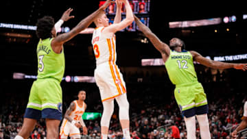 Jan 19, 2022; Atlanta, Georgia, USA; Atlanta Hawks guard Kevin Huerter (3) shoots over Minnesota Timberwolves forward Taurean Prince (12) during the second half at State Farm Arena. Mandatory Credit: Dale Zanine-USA TODAY Sports