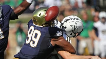 SOUTH BEND, IN - SEPTEMBER 15: Jerry Tillery #99 of the Notre Dame Fighting Irish hits Kyle Shurmur #14 of the Vanderbilt Commodores as he passes forcing a fumble at Notre Dame Stadium on September 15, 2018 in South Bend, Indiana. (Photo by Jonathan Daniel/Getty Images)