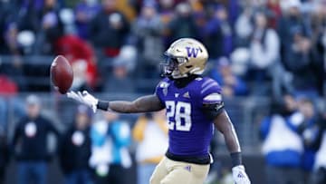 Nov 29, 2019; Seattle, WA, USA; Washington Huskies running back Richard Newton (28) flips the ball after scoring a touchdown against the Washington State Cougars during the second quarter at Husky Stadium. Mandatory Credit: Jennifer Buchanan-USA TODAY Sports