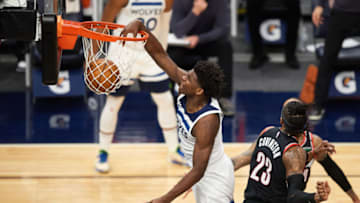 Anthony Edwards of the Minnesota Timberwolves dunks the ball against Robert Covington. (Photo by Hannah Foslien/Getty Images)