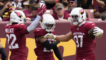 Sep 10, 2023; Landover, Maryland, USA; Arizona Cardinals safety K'Von Wallace (22) cornerback Marco Wilson (20) and linebacker Cameron Thomas (97) celebrate after scoring a touchdown against the Washington Commanders in the second half at FedExField. Mandatory Credit: Brent Skeen-USA TODAY Sports