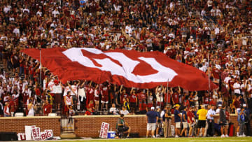 NORMAN, OK - SEPTEMBER 25: Oklahoma Sooners student fans hold up an OU flag against the West Virginia Mountaineers before the start of the fourth quarter at Gaylord Family Oklahoma Memorial Stadium on September 25, 2021 in Norman, Oklahoma. Oklahoma won 16-13. (Photo by Brian Bahr/Getty Images)