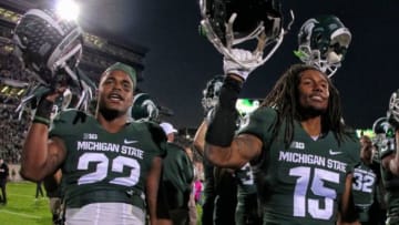 Oct 25, 2014; East Lansing, MI, USA; Michigan State Spartans cornerback Trae Waynes (15) and Michigan State Spartans running back Delton Williams (22) celebrate win after a game at Spartan Stadium. Mandatory Credit: Mike Carter-USA TODAY Sports