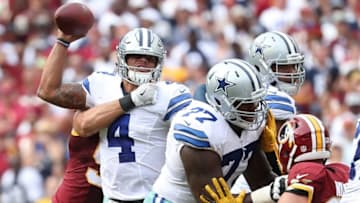 Sep 18, 2016; Landover, MD, USA; Dallas Cowboys quarterback Dak Prescott (4) throws the ball while being tackled by Washington Redskins linebacker Ryan Kerrigan (91) in the fourth quarter at FedEx Field. The Cowboys won 27-23. Mandatory Credit: Geoff Burke-USA TODAY Sports