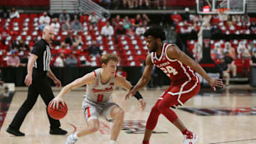 Feb 1, 2021; Lubbock, Texas, USA; Texas Tech Red Raiders guard Mac McClung (0) works the ball against Oklahoma Sooners guard Elijah Harkless (24) in the first half at United Supermarkets Arena. Mandatory Credit: Michael C. Johnson-USA TODAY Sports