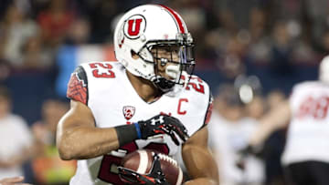 Nov 14, 2015; Tucson, AZ, USA; Utah Utes running back Devontae Booker (23) runs the ball against the Arizona Wildcats during the first quarter at Arizona Stadium. Mandatory Credit: Casey Sapio-USA TODAY Sports