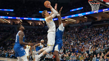 Nov 4, 2023; Minneapolis, Minnesota, USA; Utah Jazz forward Lauri Markkanen (23) shoots against Minnesota Timberwolves center Naz Reid (11) in the third quarter at Target Center. Mandatory Credit: Matt Blewett-USA TODAY Sports