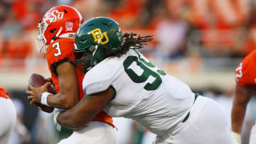 STILLWATER, OK - OCTOBER 19: Defensive tackle Bravvion Roy #99 of the Baylor University Bears sacks quarterback Spencer Sanders #3 of the Oklahoma State Cowboys for a loss of seven yards late in the fourth quarter on October 19, 2019 at Boone Pickens Stadium in Stillwater, Oklahoma. Baylor stayed undefeated with a 45-27 road win. (Photo by Brian Bahr/Getty Images)