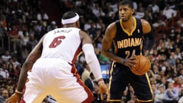 Apr 11, 2014; Miami, FL, USA; Indiana Pacers forward Paul George (24) is pressured by Miami Heat forward LeBron James (6) during the second half at American Airlines Arena. Miami won 98-86. Mandatory Credit: Steve Mitchell-USA TODAY Sports
