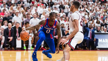 Guard Marcus Garrett of Kansas basketball handles the ball against forward TJ Holyfield. (Photo by John E. Moore III/Getty Images)