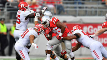 COLUMBUS, OH - OCTOBER 1: Antonio Williams #26 of the Ohio State Buckeyes is brought down by Anthony Cioffi #31 of the Rutgers Scarlet Knights and Kevin Marquez #40 of the Rutgers Scarlet Knights after a gain in the fourth quarter at Ohio Stadium on October 1, 2016 in Columbus, Ohio. Ohio State defeated Rutgers 58-0. (Photo by Jamie Sabau/Getty Images)