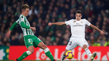 SEVILLE, SPAIN - JANUARY 13: Giovani Lo Celso of Real Betis Balompie (L) competes for the ball with Sergio Reguilon of Real Madrid CF (R) during the La Liga match between Real Betis Balompie and Real Madrid CF at Estadio Benito Villamarin on January 13, 2019 in Seville, Spain. (Photo by Aitor Alcalde/Getty Images)