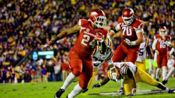 Nov 14, 2015; Baton Rouge, LA, USA; Arkansas Razorbacks running back Kody Walker (24) runs against the LSU Tigers during the second half of a game at Tiger Stadium. Arkansas defeated LSU 31-14. Mandatory Credit: Derick E. Hingle-USA TODAY Sports