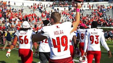 Oct 29, 2016; Charlottesville, VA, USA; Louisville Cardinals long snapper Colin Holba (49) celebrates with teammates while leaving the field after the Cardinals