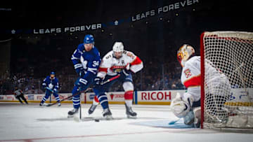 TORONTO, ON - MARCH 25: Auston Matthews #34 of the Toronto Maple Leafs goes to the net against Aaron Ekblad #5 of the Florida Panthers and Roberto Luongo #1 during the third period at the Scotiabank Arena on March 25, 2019 in Toronto, Ontario, Canada. (Photo by Mark Blinch/NHLI via Getty Images)