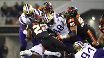 CORVALLIS, OREGON - NOVEMBER 08: Jermar Jefferson #22 of the Oregon State Beavers is tackled by the Washington Huskies in the fourth quarter during their game at Reser Stadium on November 08, 2019 in Corvallis, Oregon. (Photo by Abbie Parr/Getty Images)