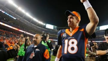 Oct 19, 2014; Denver, CO, USA; Denver Broncos quarterback Peyton Manning (18) waves to the crowd as he runs off the field after the game against the San Francisco 49ers at Sports Authority Field at Mile High. Mandatory Credit: Chris Humphreys-USA TODAY Sports