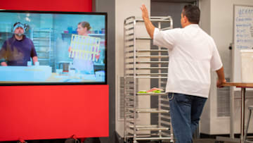 Host Buddy Valastro waves to Team Duff, as seen on Buddy vs Duff, Season 3. Photo courtesy Food Network