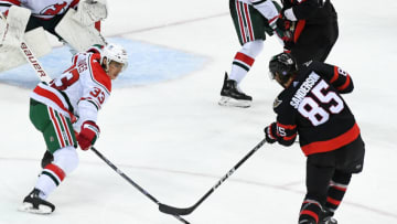 New Jersey Devils defenseman Ryan Graves (33) blocks the shot of Ottawa Senators defenseman Jake Sanderson (85) during the third period at Prudential Center. Mandatory Credit: Dennis Schneidler-USA TODAY Sports
