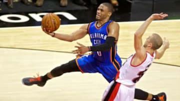 Oct 29, 2014; Portland, OR, USA; Oklahoma City Thunder guard Russell Westbrook (0) shoots over Portland Trail Blazers guard Steve Blake (25) during the third quarter at the Moda Center. Mandatory Credit: Craig Mitchelldyer-USA TODAY Sports