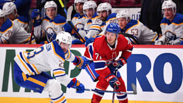 MONTREAL, QC - FEBRUARY 13: Mattias Samuelsson #23 of the Buffalo Sabres and Jake Evans #71 of the Montreal Canadiens skate against each other during the second period at Centre Bell on February 13, 2022 in Montreal, Canada. (Photo by Minas Panagiotakis/Getty Images)