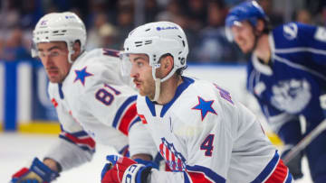 SYRACUSE, NY - APRIL 22: Jeremy Davies #4 of Rochester Americans and Brett Murray #81 of Rochester Americans rush for the puck during the third period against the Syracuse Crunch during Game 2 of the north division semifinals of the Calder Cup Playoffs at Upstate Medical University Arena on April 22, 2023 in Syracuse, New York. (Photo by Isaiah Vazquez/Getty Images)