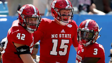 CHARLOTTE, NC - SEPTEMBER 02: Teammates Dylan Autenrieth #42, Ryan Finley #15 and Kelvin Harmon #3 of the North Carolina State Wolfpack react after a touchdown against the South Carolina Gamecocks during their game at Bank of America Stadium on September 2, 2017 in Charlotte, North Carolina. (Photo by Streeter Lecka/Getty Images)
