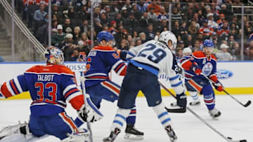 Dec 11, 2016; Edmonton, Alberta, CAN; Winnipeg Jets forward Patrik Laine (29) tries to tip a shot past Edmonton Oilers goaltender Cam Talbot (33) during the third period at Rogers Place. Mandatory Credit: Perry Nelson-USA TODAY Sports