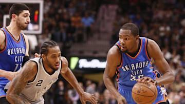 Mar 12, 2016; San Antonio, TX, USA; Oklahoma City Thunder small forward Kevin Durant (35) dribbles the ball as San Antonio Spurs small forward Kawhi Leonard (2) defends during the second half at AT&T Center. Mandatory Credit: Soobum Im-USA TODAY Sports
