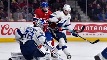Jan 2, 2020; Montreal, Quebec, CAN; Tampa Bay Lightning goalie Andrei Vasilesvskiy (88) makes a save in front of Montreal Canadiens forward Phillip Danault (24) with the assistance of defenceman Victor Hedman (77) during the second period at the Bell Centre. Mandatory Credit: Eric Bolte-USA TODAY Sports