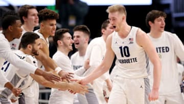 MILWAUKEE, WISCONSIN - JANUARY 20: Sam Hauser #10 of the Marquette Golden Eagles celebrates with his teammates in the second half against the Providence Friars at the Fiserv Forum on January 20, 2019 in Milwaukee, Wisconsin. (Photo by Dylan Buell/Getty Images)