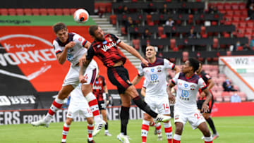 BOURNEMOUTH, ENGLAND - JULY 19: Jannik Vestergaard of Southampton battles for possession with in the air with Steve Cook of AFC Bournemouth during the Premier League match between AFC Bournemouth and Southampton FC at Vitality Stadium on July 19, 2020 in Bournemouth, England. Football Stadiums around Europe remain empty due to the Coronavirus Pandemic as Government social distancing laws prohibit fans inside venues resulting in all fixtures being played behind closed doors. (Photo by Mike Hewitt/Getty Images)
