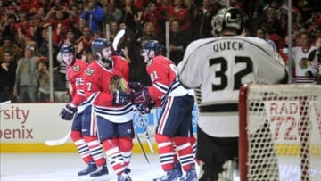 Jun 2, 2013; Chicago, IL, USA; Chicago Blackhawks defenseman Brent Seabrook (7) celebrates with right wing Marian Hossa (81) and left wing Bryan Bickell (29) after scoring a goal against Los Angeles Kings goalie Jonathan Quick (32) during the first period in game two of the Western Conference finals of the 2013 Stanley Cup Playoffs at the United Center. Mandatory Credit: Rob Grabowski-USA TODAY Sports