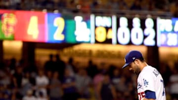 LOS ANGELES, CA - AUGUST 13: Scott Alexander #75 of the Los Angeles Dodgers reacts trailing 4-2 to the San Francisco Giants during the ninth inning at Dodger Stadium on August 13, 2018 in Los Angeles, California. (Photo by Harry How/Getty Images)