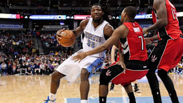 Dec 28, 2014; Denver, CO, USA; Denver Nuggets forward Kenneth Faried (35) drives to the basket against Toronto Raptors guard Kyle Lowry (7) in the fourth quarter at Pepsi Center. The Raptors defeated the Nuggets 116-102. Mandatory Credit: Isaiah J. Downing-USA TODAY Sports