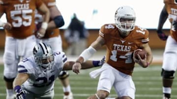 Sep 21, 2013; Austin, TX, USA; Texas Longhorns quarterback David Ash (14) runs and avoids the tackle by Kansas State Wildcats linebacker Jonathan Truman (21) during a football game at Darrell K Royal-Texas Memorial Stadium. Mandatory Credit: Jim Cowsert-USA TODAY Sports