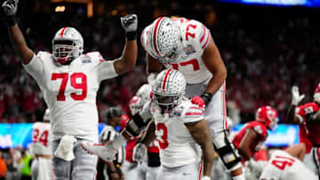 Dec 31, 2022; Atlanta, Georgia, USA; Ohio State Buckeyes running back Miyan Williams (3) celebrates a rushing touchdown with offensive lineman Paris Johnson Jr. (77) against Georgia Bulldogs during the second quarter of the Peach Bowl in the College Football Playoff semifinal at Mercedes-Benz Stadium.Osu22uga Kwr 26