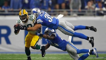 DETROIT, MI - JANUARY 1: Ty Montgomery #88 of the Green Bay Packers tires to escape the tackle of Miles Killebrew #35 of the Detroit Lions and Nevin Lawson #24 at Ford Field on January 1, 2017 in Detroit, Michigan. (Photo by Gregory Shamus/Getty Images)
