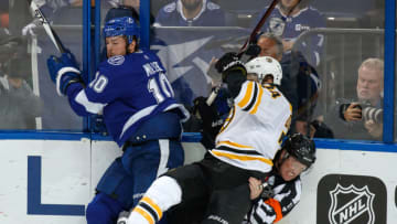 TAMPA, FL - APRIL 30: J.T. Miller #10 of the Tampa Bay Lightning checks Jake DeBrusk #74 of the Boston Bruins into referee Kelly Sutherland #11 during Game Two of the Eastern Conference Second Round during the 2018 NHL Stanley Cup Playoffs at Amalie Arena on April 30, 2018 in Tampa, Florida. (Photo by Mike Carlson/NHLI via Getty Images)