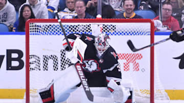 Oct 21, 2023; Buffalo, New York, USA; Buffalo Sabres goaltender Eric Comrie (31) makes a stop on the puck in the second period against the New York Islanders Lane Lambert () at KeyBank Center. Mandatory Credit: Mark Konezny-USA TODAY Sports