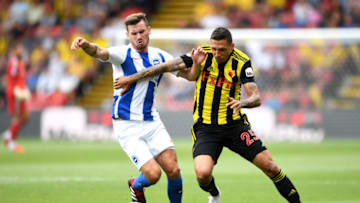 WATFORD, ENGLAND - AUGUST 11: Jose Holebas of Watford is challenged by Pascal Gross of Brighton and Hove Albion during the Premier League match between Watford FC and Brighton & Hove Albion at Vicarage Road on August 11, 2018 in Watford, United Kingdom. (Photo by Michael Regan/Getty Images)