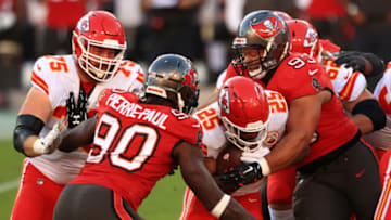 TAMPA, FLORIDA - NOVEMBER 29: Clyde Edwards-Helaire #25 of the Kansas City Chiefs attempts to break a tackle from Jason Pierre-Paul #90 and Ndamukong Suh #93 of the Tampa Bay Buccaneers in the first quarter during their game at Raymond James Stadium on November 29, 2020 in Tampa, Florida. (Photo by Mike Ehrmann/Getty Images)