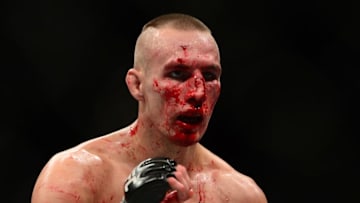 Jul 11, 2015; Las Vegas, NV, USA; Robbie Lawler (not pictured) and Rory MacDonald (blue gloves) fight during their welterweight title bout during UFC 189 at MGM Grand Garden Arena. Lawler won via fifth round TKO. Mandatory Credit: Joe Camporeale-USA TODAY Sports