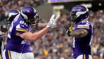 MINNEAPOLIS, MN - JANUARY 1: Jerick McKinnon #21 and Kyle Rudolph #82 of the Minnesota Vikings celebrate after McKinnon scored a 10 yard touchdown run in the third quarter of the game against the Chicago Bears on January 1, 2017 at US Bank Stadium in Minneapolis, Minnesota. (Photo by Hannah Foslien/Getty Images)
