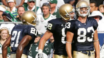 SOUTH BEND, IN - SEPTEMBER 17: Wide receiver Jeff Samardzija #83 of the Notre Dame Fighting Irish stands in the end zone after scoring a touchdown as teammates Anthony Fasano #88 and Maurice Stovall #21 celebrate in the first half against the Michigan State on September 17, 2005 at Notre Dame Stadium in South Bend, Indiana. (Photo by Elsa/Getty Images)