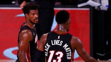 LAKE BUENA VISTA, FLORIDA - AUGUST 18: Bam Adebayo #13 of the Miami Heat and Jimmy Butler #22 of the Miami Heat react after their win over the Indiana Pacers in Game One of the Eastern Conference First Round during the 2020 NBA Playoffs at AdventHealth Arena at ESPN Wide World Of Sports Complex on August 18, 2020 in Lake Buena Vista, Florida. NOTE TO USER: User expressly acknowledges and agrees that, by downloading and or using this photograph, User is consenting to the terms and conditions of the Getty Images License Agreement. (Photo by Mike Ehrmann/Getty Images)