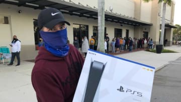 Alijah Roman shows the PS5 he scored after waiting most of Thanksgiving Day and all night in line at GameStop at Market Square in Fort Myers on Friday, Nov. 27, 2020.Fnp 112620 Dd Blackfridayps5