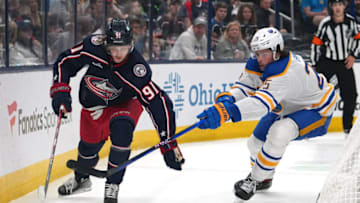 COLUMBUS, OHIO - OCTOBER 04: Kent Johnson #91 of the Columbus Blue Jackets and Owen Power #25 of the Buffalo Sabres battle for the puck during the second period at Nationwide Arena on October 04, 2023 in Columbus, Ohio. (Photo by Jason Mowry/Getty Images)